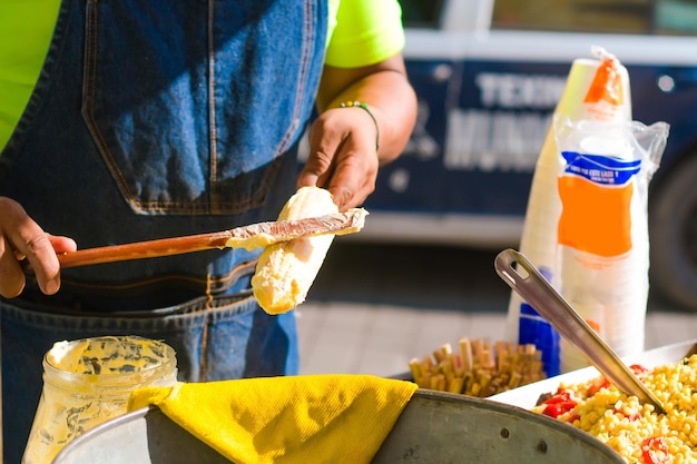 Preparing elotes traditional Mexican street food