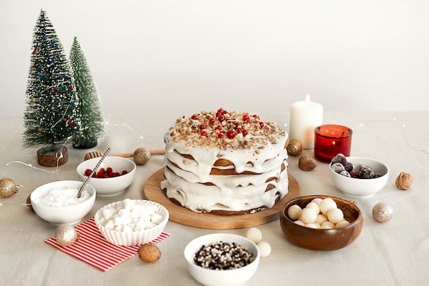 Preparing food for Christmas dinner Homemade cake with white icing sugar nuts and red cranberries