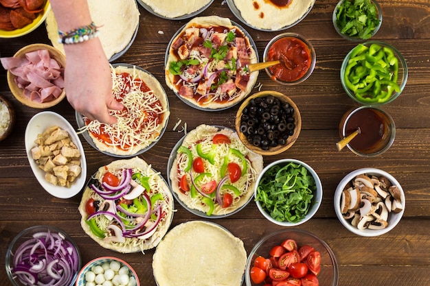 Preparing individual pizzas from pizza bar.