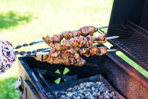 Photo preparing pork shashlik on the charcoal mangal. pork grill, marinated shashlik on a barbecue grill.