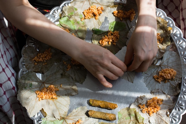 Preparing stuffed vine leaves with rice and meat or traditional Sarma