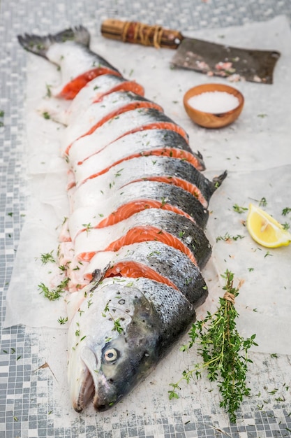 Preparing whole salmon with thyme and salt