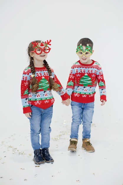 Preschool boy girl in Christmas sweaters