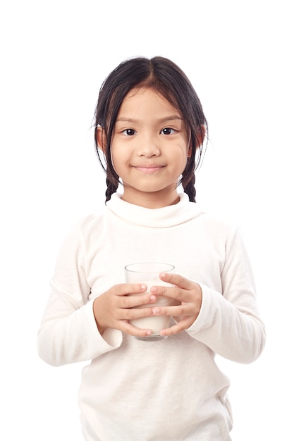 Preschool girl holding a glass with milk 