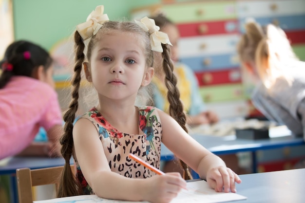 Preschool girl studying at the table