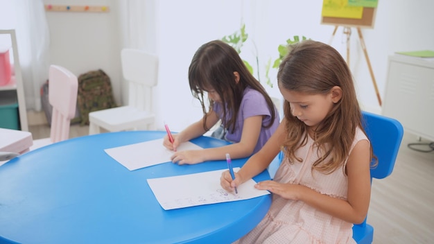 Preschool teacher with children study in classroom. Kindergarten back to school