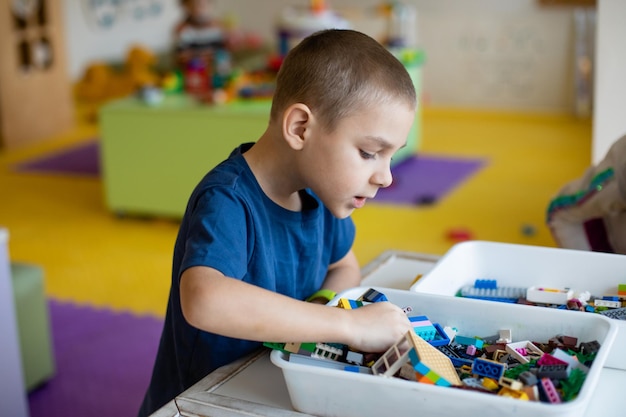 The preschooler looks for the necessary toy detail