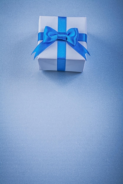 Present box on blue background copy space