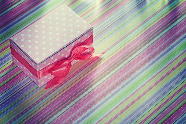 Present box on striped tablecloth horizontal image celebrations concept