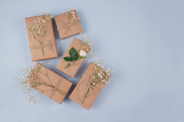 Present boxes with floral decoration on grey table