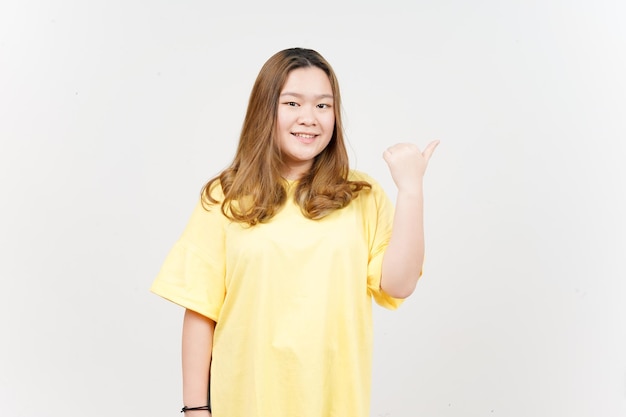 Presenting and Pointing Side Product Using Thumb of Beautiful Asian Woman wearing yellow TShirt