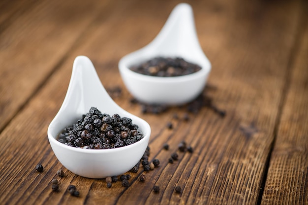 Preserved black Peppercorns on a wooden table