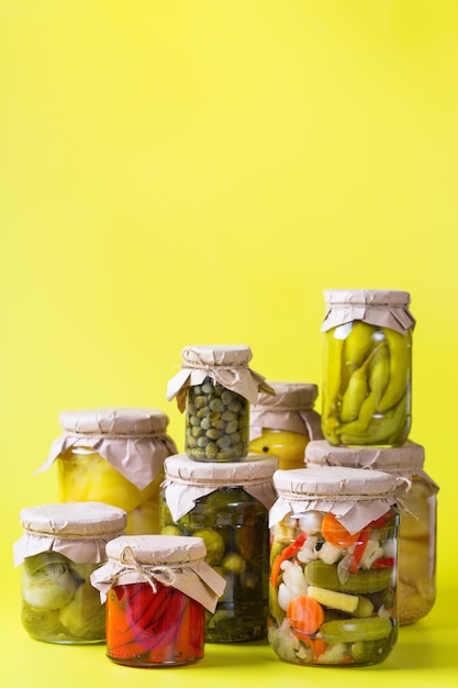 Preserved and fermented food. Assortment of homemade jars with variety of pickled and marinated vegetables on a table. Housekeeping, home economics, harvest preservation