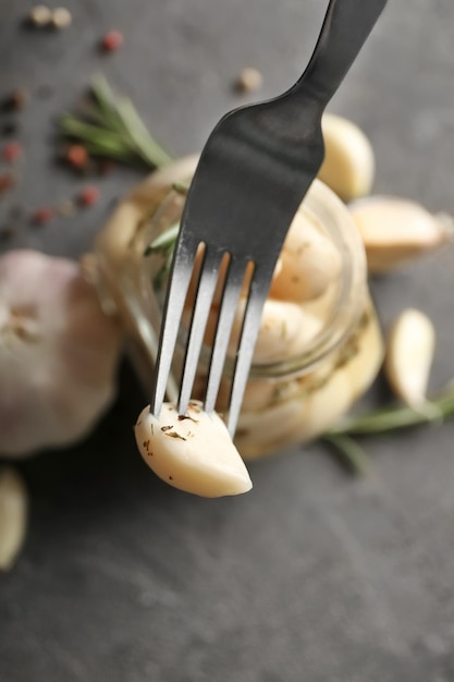 Preserved garlic on fork closeup