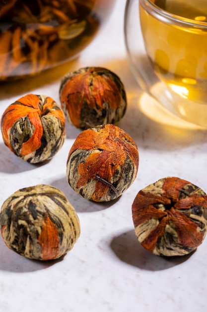 Pressed Green Chinese Oolong Tea Balls blooms in a teapot in the form of a flower