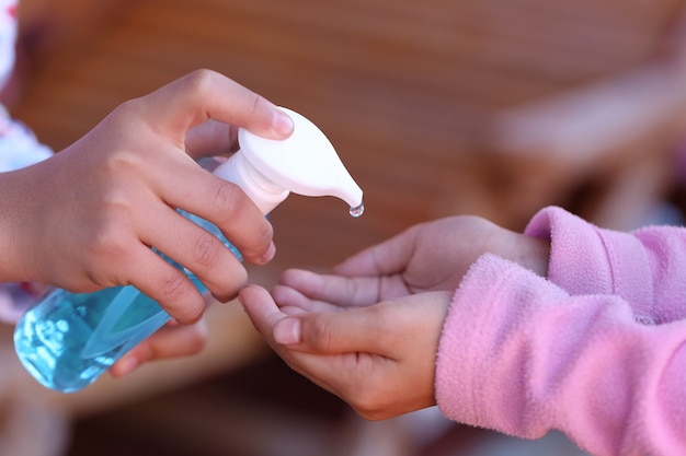 Pressing the alcohol bottle for taking care of physical health and hand hygiene