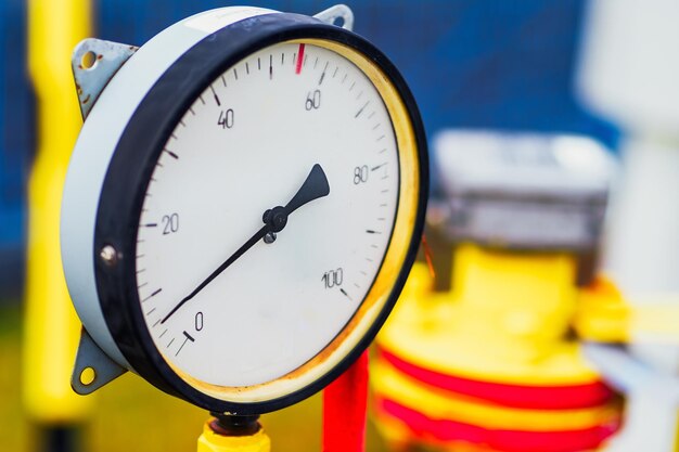 Pressure gauge with arrow shows gas pressure in pipe Industrial pressure measurement sensor closeup