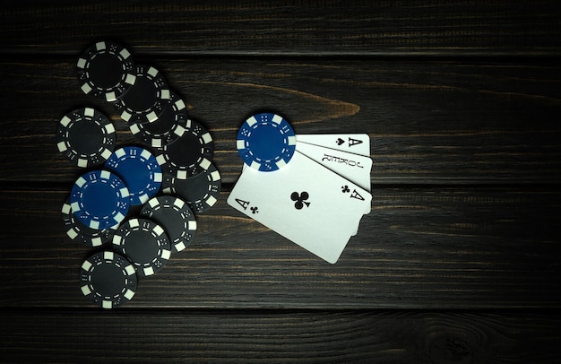 Prestigious poker game with a winning three of a kind combination Cards with chips on a black table in a poker club Free space for advertising