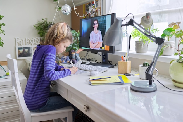 Preteen girl learning math online using home computer