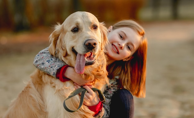 Preteen girl with golden retriever dog