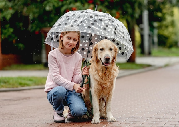 Preteen girl with golden retriever dog