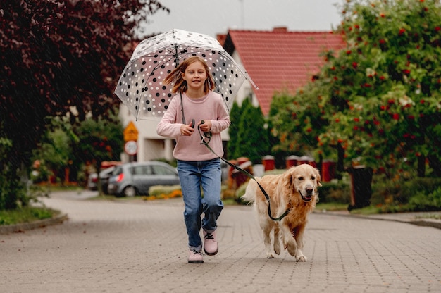 Preteen girl with golden retriever dog