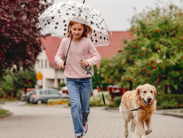 Preteen girl with golden retriever dog