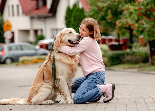 Preteen girl with golden retriever dog