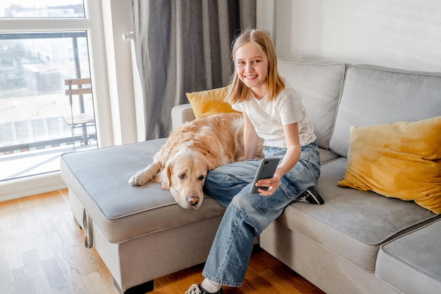 Preteen girl with golden retriever at home