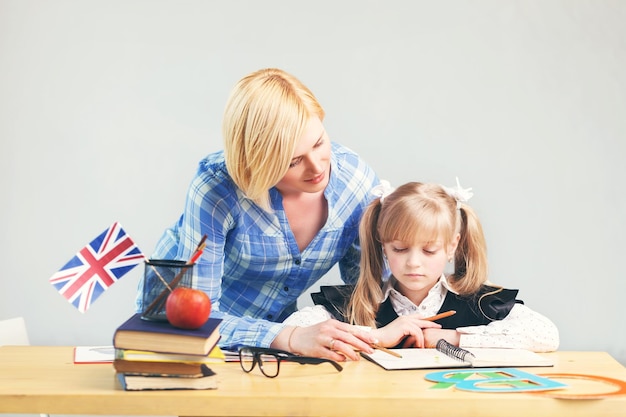 Pretty adult female teacher helps kid