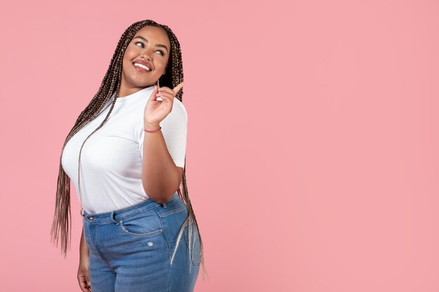 Pretty African American Obese Woman Pointing Finger Aside Pink Background