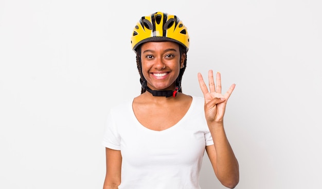 Pretty afro woman with braids with a bike helmet