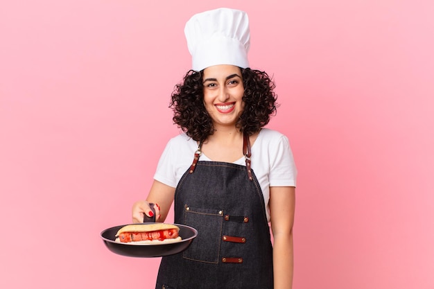 Pretty arab woman barbecue chef preparing hot dogs