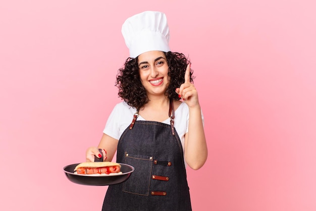 Pretty arab woman barbecue chef preparing hot dogs