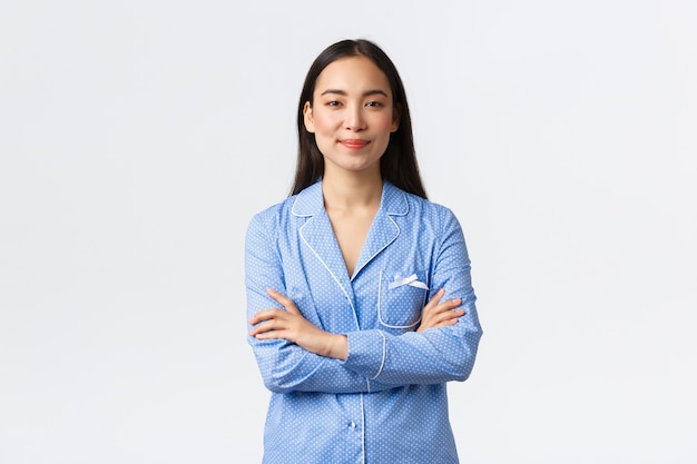 Pretty Asian girl in blue pajamas posing