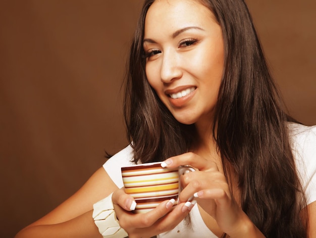 Pretty asian woman drinking coffee