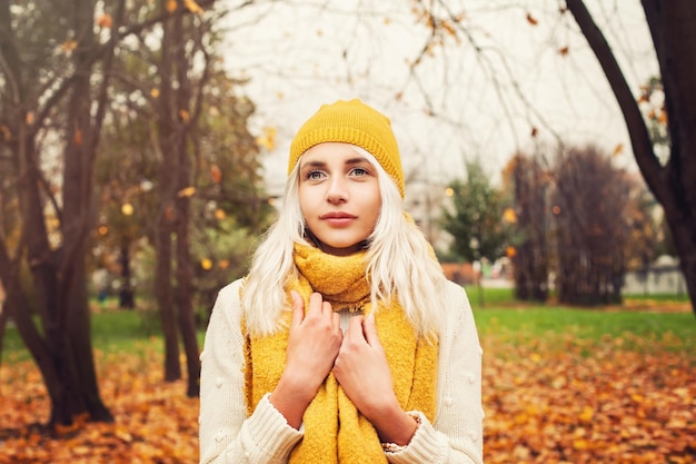 Pretty Autumn Woman with Yellow Cotton Scarf and Hat Outdoors