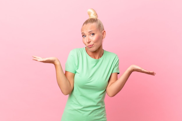 Pretty blond woman feeling puzzled and confused and doubting