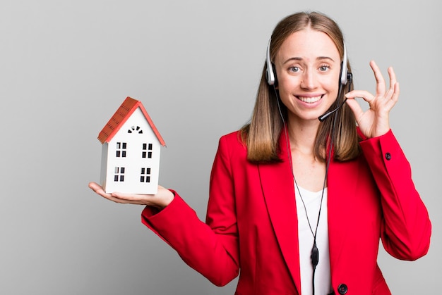 Pretty blonde businesswoman real state telemarketer concept