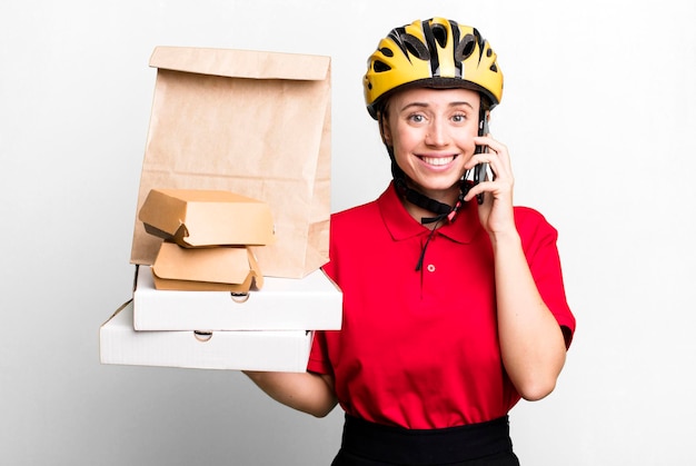 Pretty blonde deliverywoman with a paper bag