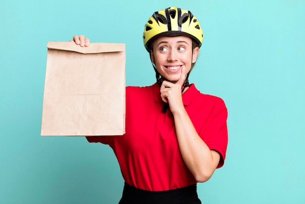 Pretty blonde deliverywoman with a paper bag