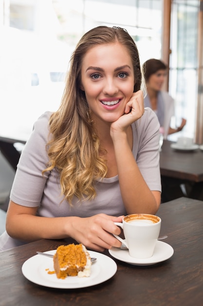 Pretty blonde enjoying cake and coffee