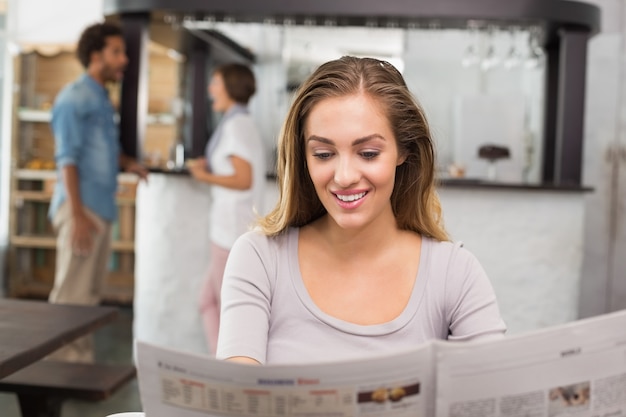 Pretty blonde reading the newspaper