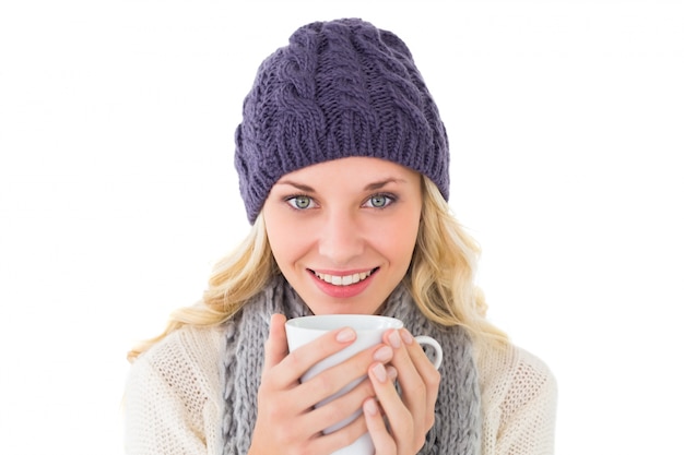 Pretty blonde in winter fashion holding mug