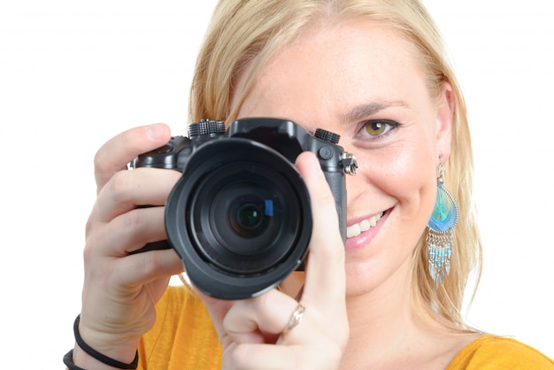 Pretty blonde woman photographer with  camera, on white