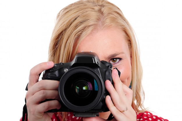 Pretty blonde woman photographer with  camera, on white