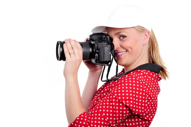 Pretty blonde woman photographer with  camera, on white