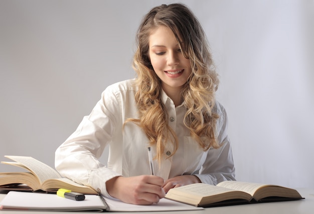 Pretty blonde woman studying