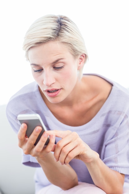 Pretty blonde woman texting with her mobile phone 