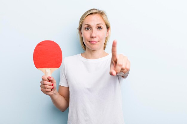 Pretty blonde young adult woman ping pong concept